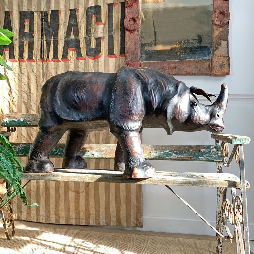 leather antique rhinoceros foots tool on a vintage garden bench with a rustic background