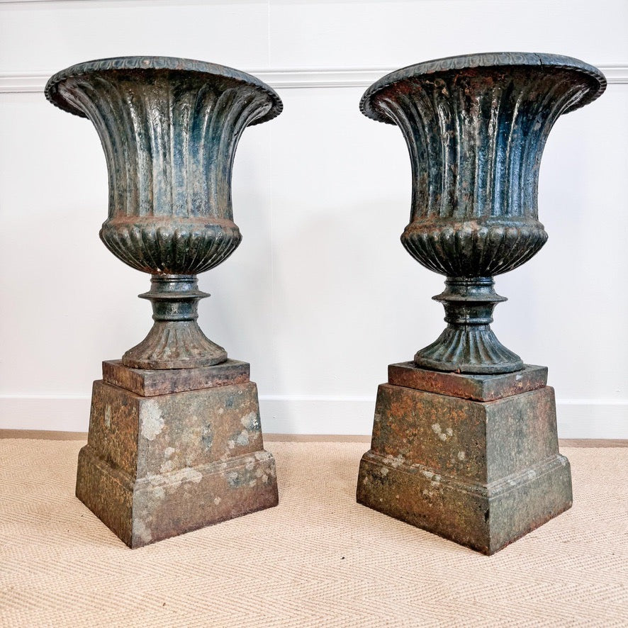Pair of High Victorian Cast Iron Campana Urns on Plinths