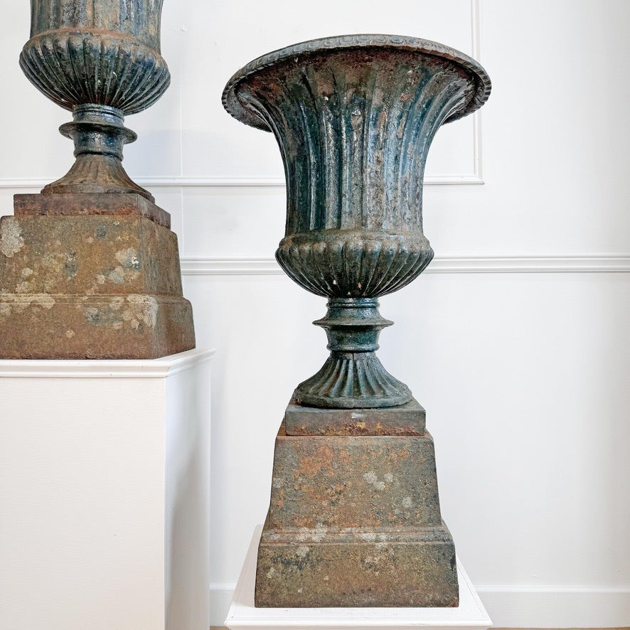 Pair of High Victorian Cast Iron Campana Urns on Plinths