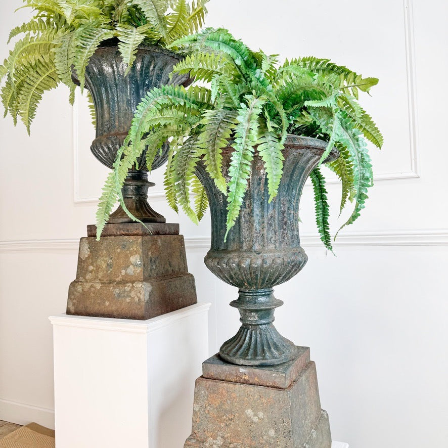 Pair of High Victorian Cast Iron Campana Urns on Plinths