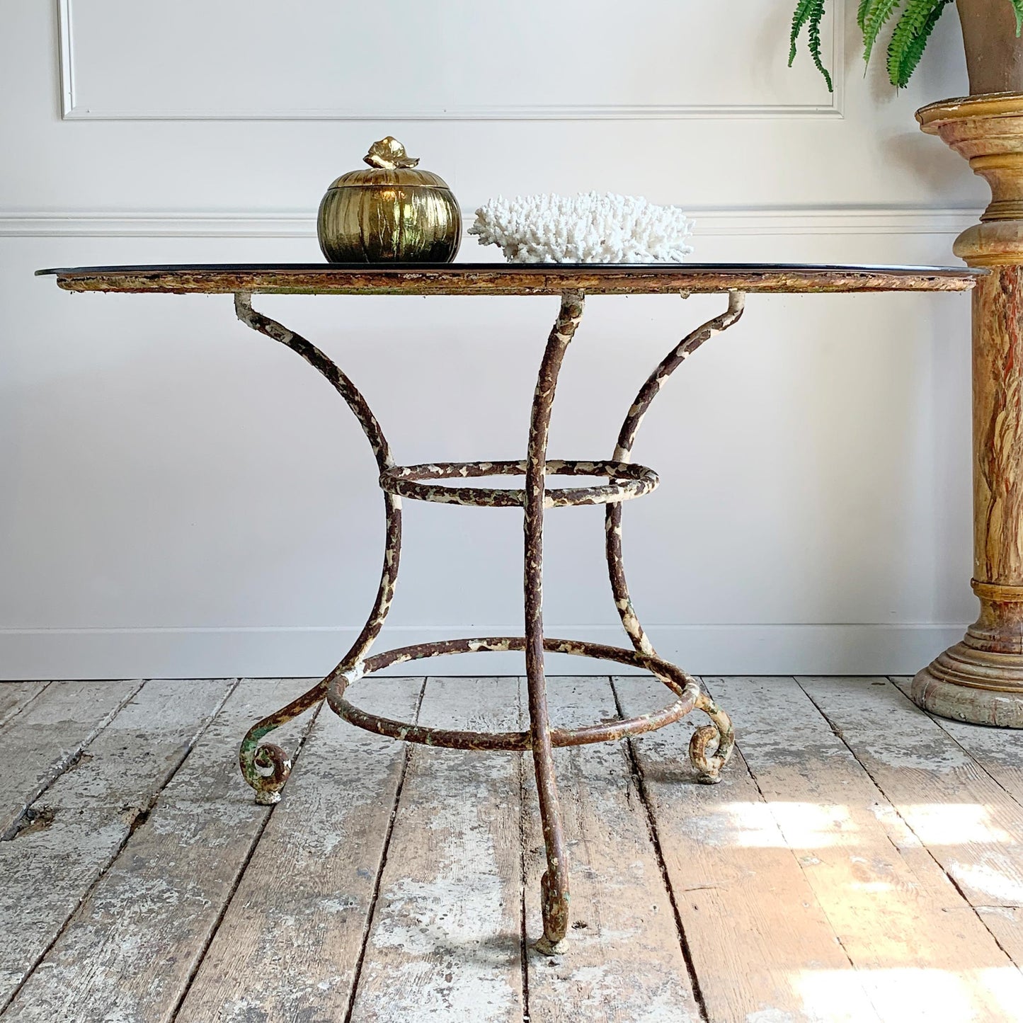 An outstanding large 19th Century Wrought Iron French Garden/Dining Table, heavy and wonderfully constructed, bearing signs of more than 140 years of worn green and cream paint on the turned legs, the patina on this solid piece is exceptional