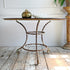 An outstanding large 19th Century Wrought Iron French Garden/Dining Table, heavy and wonderfully constructed, bearing signs of more than 140 years of worn green and cream paint on the turned legs, the patina on this solid piece is exceptional