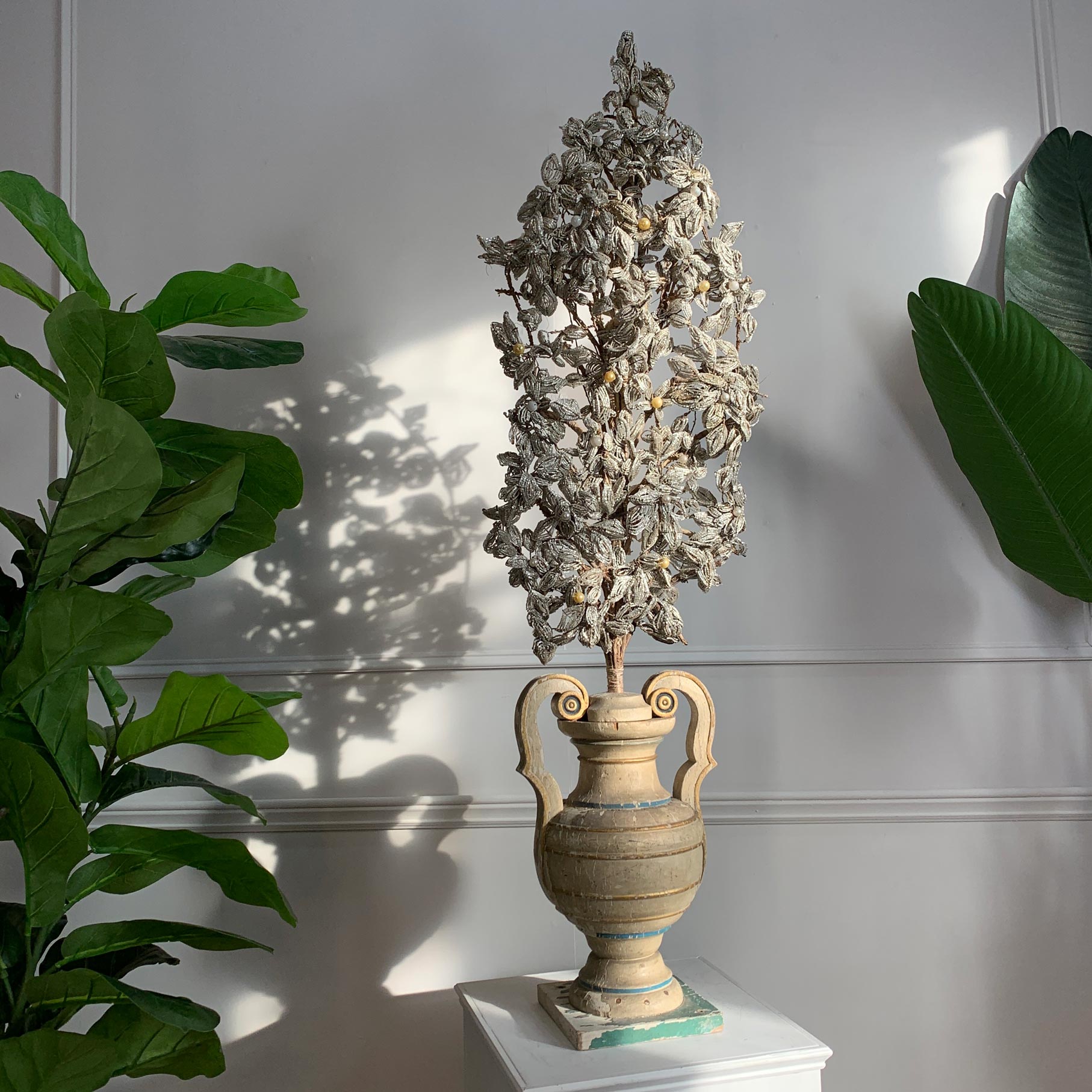 A stunning late 18th century Italian altar palmetti, hand crafted flowers made from tens of thousands of individual murano glass beads and simulated pearls, woven together to form a huge floral display and paired with an 18th century carved wood and gesso altar vase, with gilt and green accents