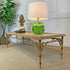 A rectangular console table with a bamboo-style frame and a light wood top, styled in a room setting with a lamp, decorative objects, and a potted plant.