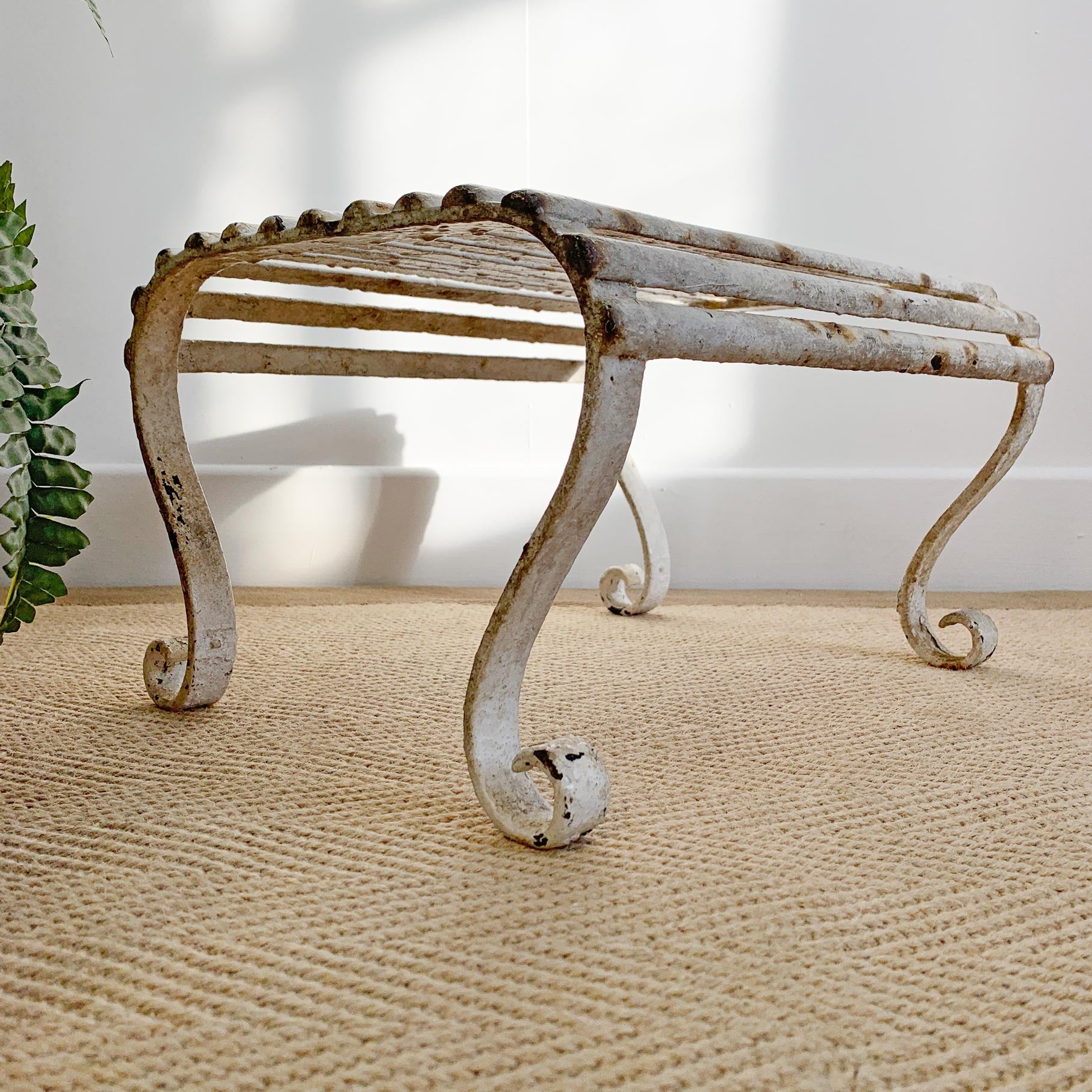 Late Regency/Early Victorian wrought Iron footstool.

Historical white paint and scroll feet.