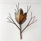 Vintage Metal wall light shaped like a branch with a textured leaf at the center, shown against a plain white wall.