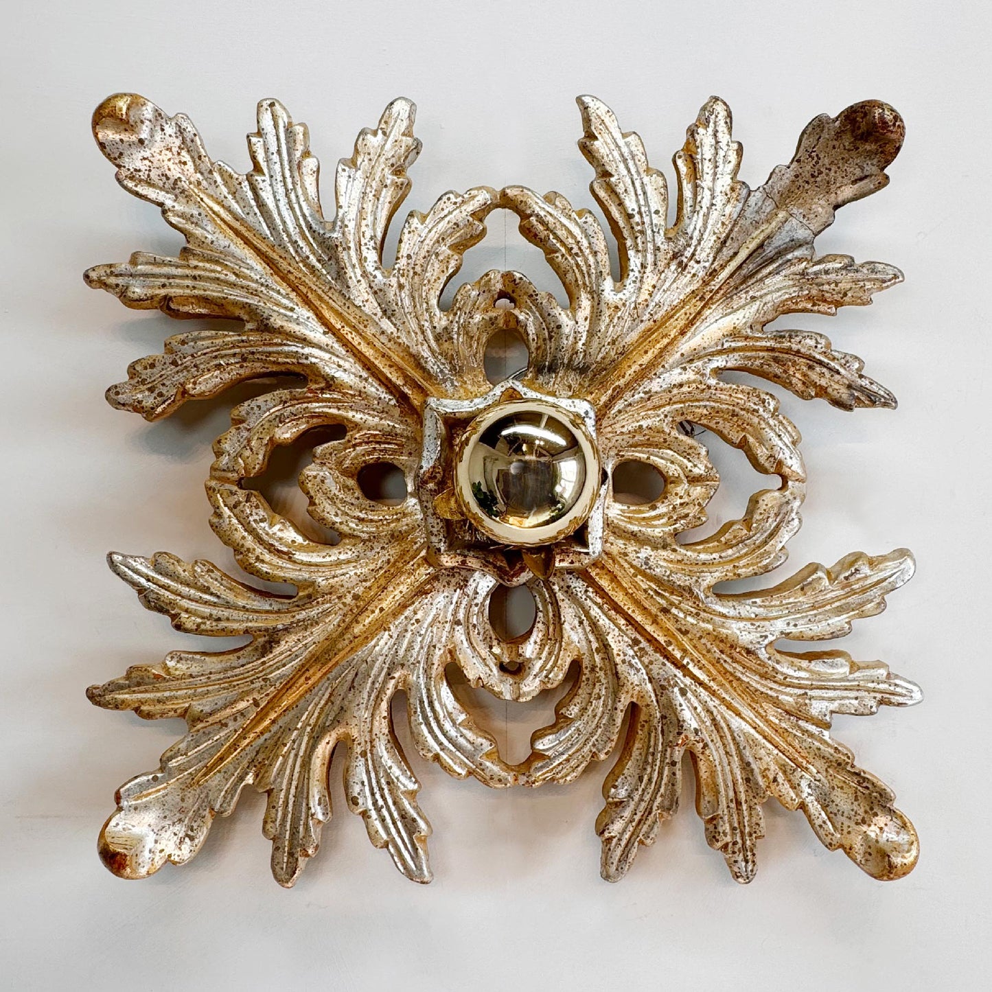 A vintage Italian ornate gold and silver leaf-shaped wall ceiling sconce with a central circular light fixture opening, photographed against a plain off-white background.