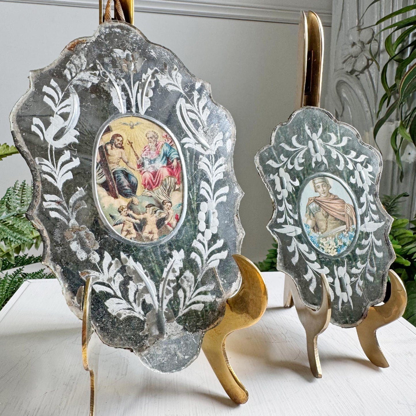 An incredible pair of reverse painted late 18th / Early 19th century Nuns' mirrors, probably southern Germany or Austrian.

These stunning pieces are in superb original condition, one depicting the Holy Trinity, and the other Saint Martin.