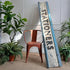 A distressed original antique wooden shop front sign reading &